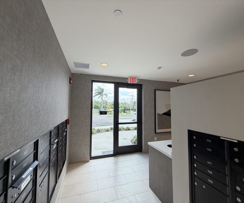 Commercial mailbox bank serviced in a community lobby