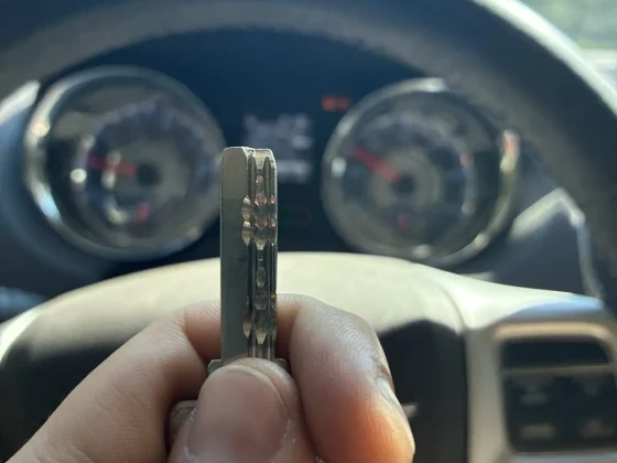 Freshly cut car key held up inside the customer's vehicle