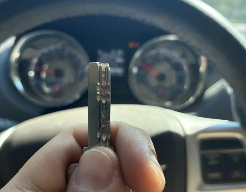 Freshly cut car key held up inside the customer's vehicle