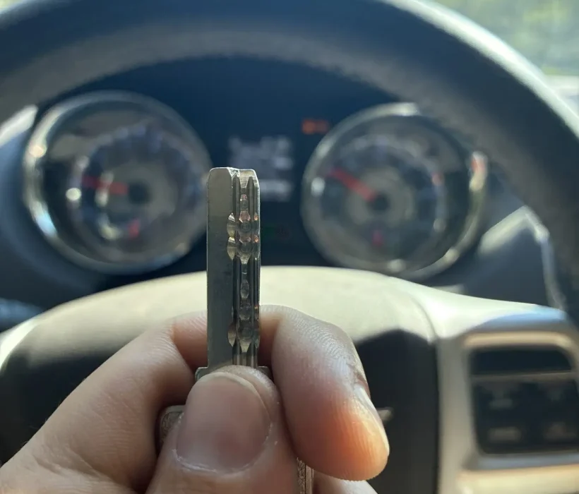 Freshly cut car key held up inside the customer's vehicle