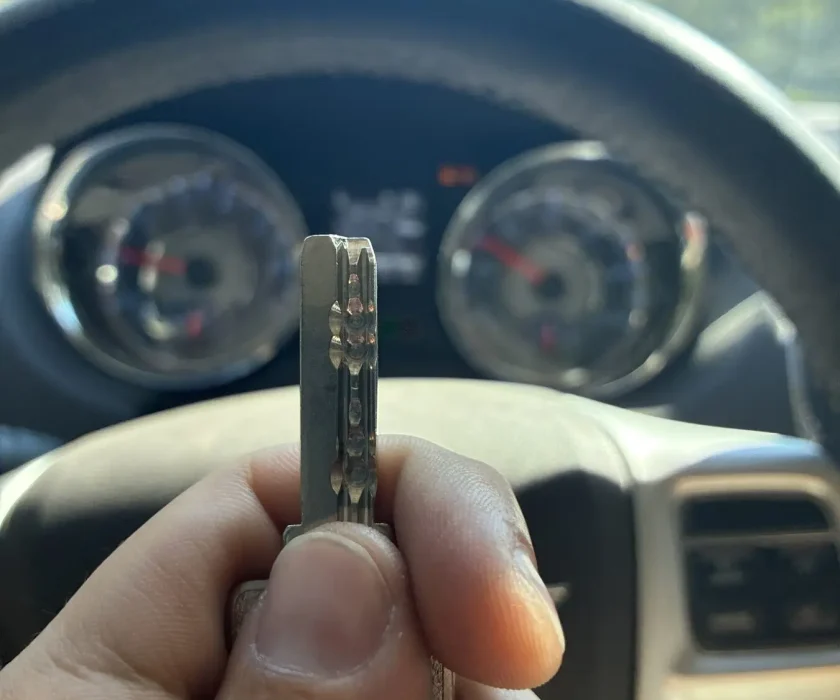 Freshly cut car key held up inside the customer's vehicle