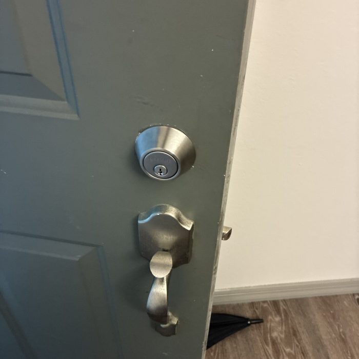 New deadbolt and handleset installed on a home front door