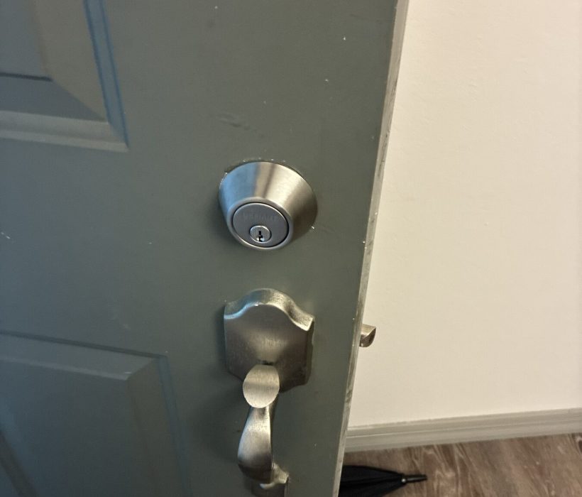 New deadbolt and handleset installed on a home front door