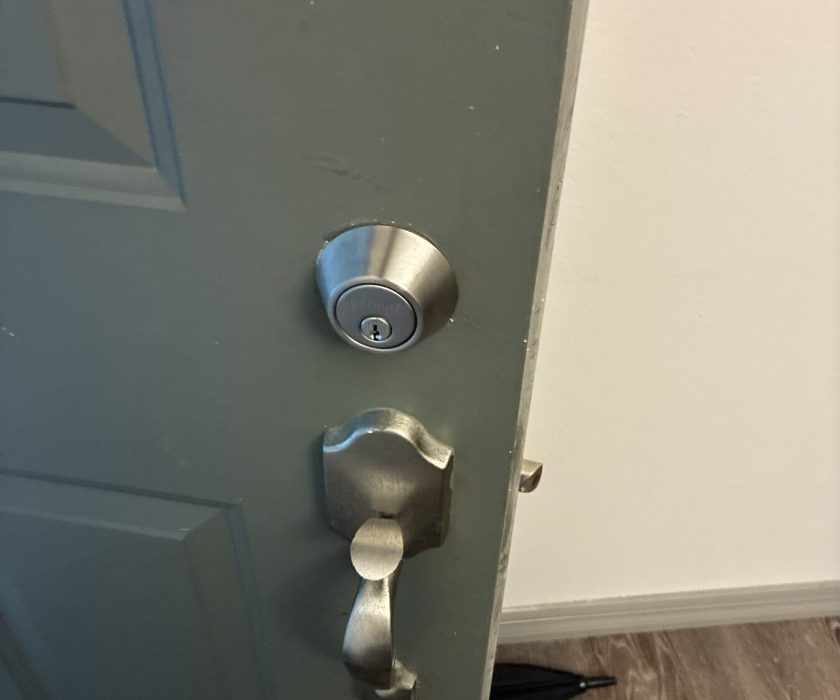 New deadbolt and handleset installed on a home front door