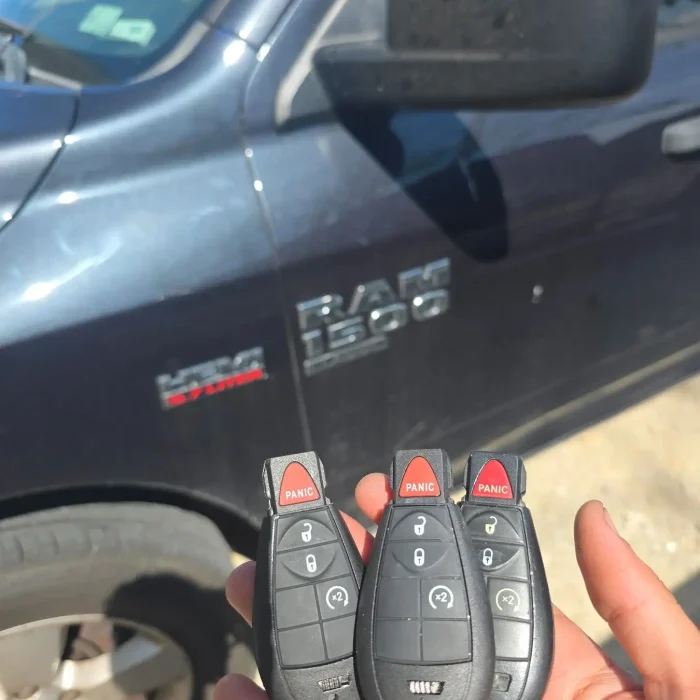 Three programmed Ram 1500 key fobs held in front of the customer's truck