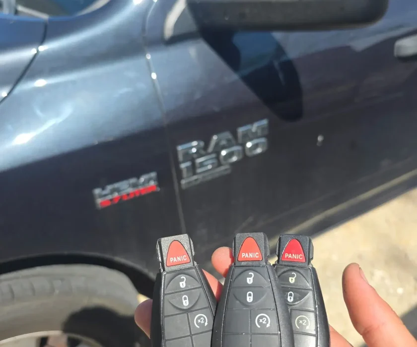 Three programmed Ram 1500 key fobs held in front of the customer's truck