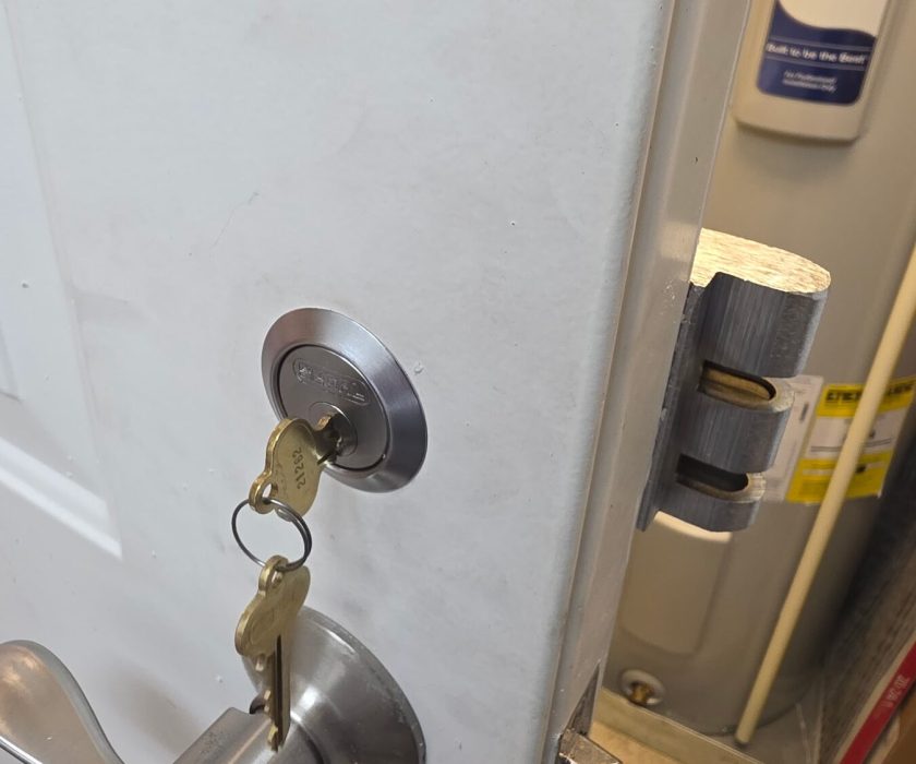 Residential deadbolt rekeyed with a new key in the cylinder