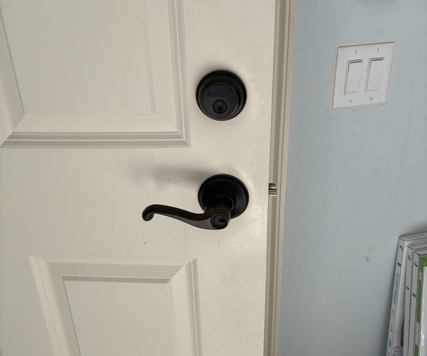 Matching lever handle and deadbolt installed on a home door