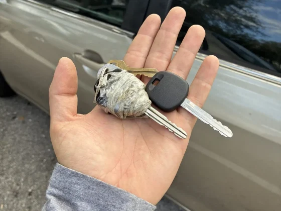 Worn original car key being replaced with a new cut and programmed key